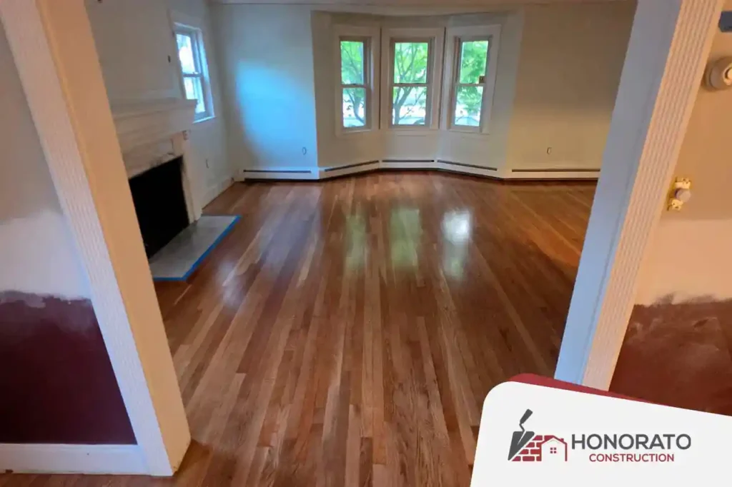 Renovated living room with refinished hardwood floors and fireplace