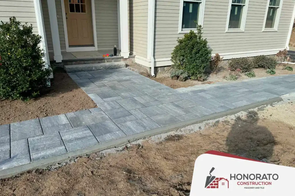 Residential paver walkway installation leading to front entrance